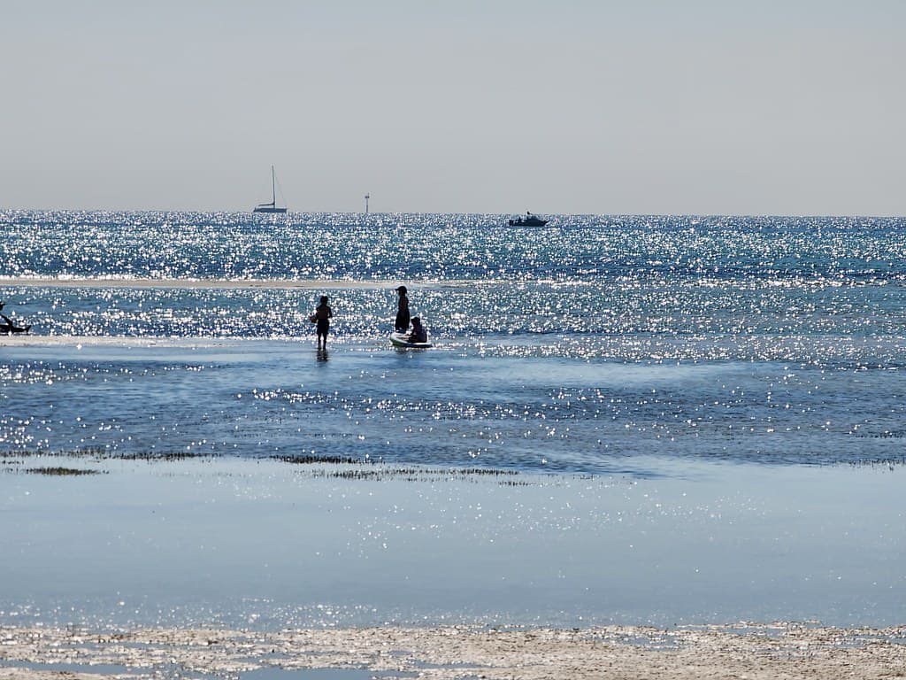Body boarding at low tide at Capel Sound Beach