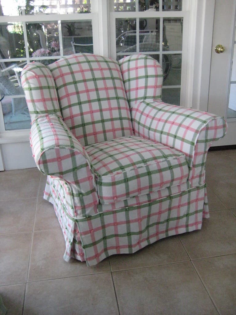 Overstuffed wing chair slip covered in plaid